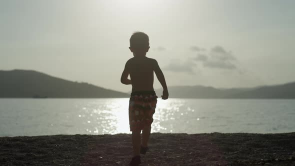 Slow Motion Video of a Baby Boy Running to the Sea alt