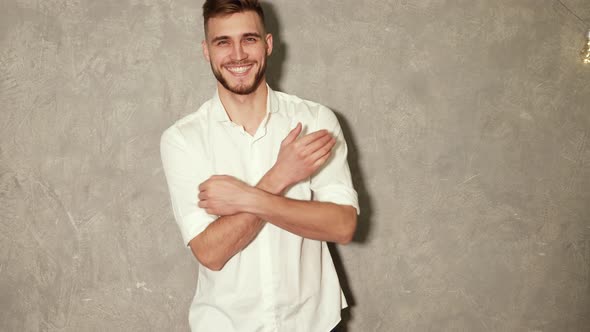 Portrait of attractive bearded stylish young man looking into the camera and smiling alt