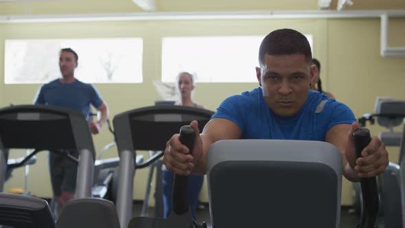 Man working out hard on stair machine at gym
