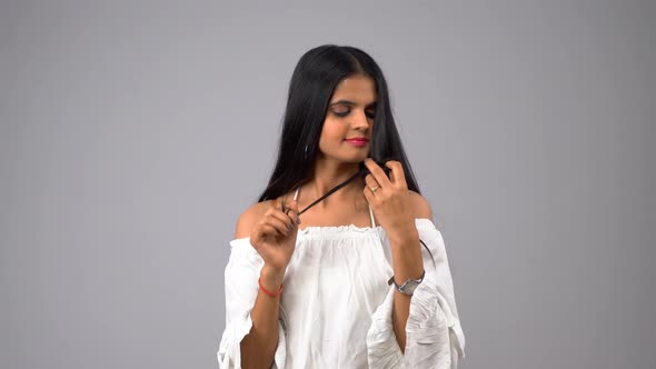 Happy Indian girl playing with hairs alt