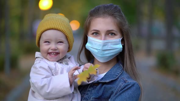 Masked Mother Holds Hand Lovely Daughter on Street Walk During Second Wave Quarantine Coronavirus alt