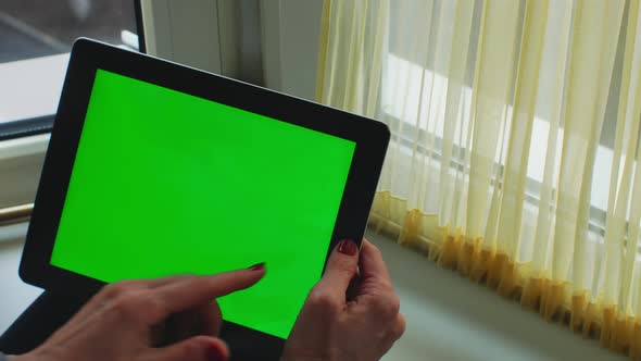 Adult Woman Holding Green Screen Tablet Computer