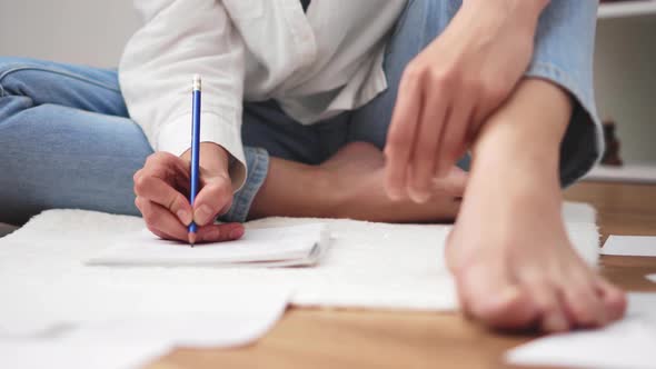 Student Girl Sits On The Floor With Bare Legs Writes Text On A Sheet Of Paper Diary. The Student alt