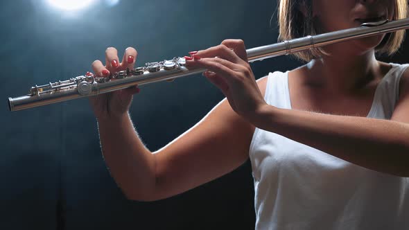 Musician Female Playing on Flute. Smoky Studio
