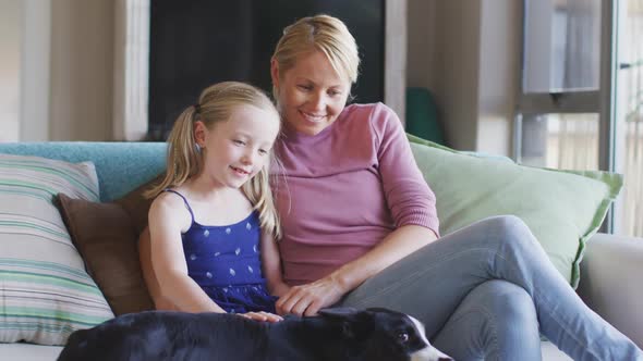Caucasian woman with her daughter at home alt
