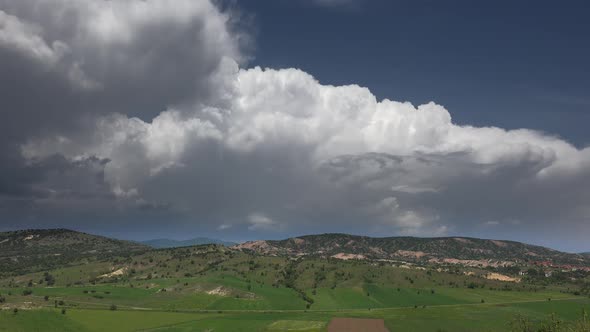 Green Fields on the Edge of Hilly Terrain alt