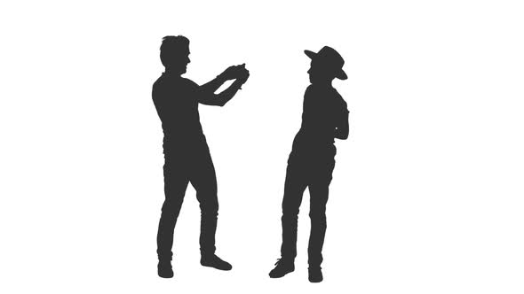 Silhouette of Father Takes a Picture of His Teen Son With Smartphone