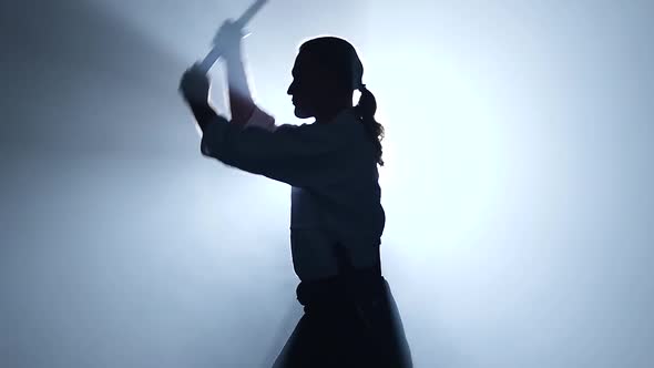 Man Fighting at Aikido Training with Japanese Sword Katana in Martial Arts School. Healthy Lifestyle alt