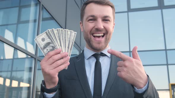 Portrait of a Business Man Holding Money alt