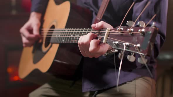 Male Hands Playing a Song on an Acoustic Guitar alt