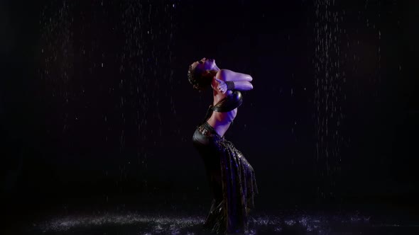 Exotic Dance Performance in Studio with Water Flows in Darkness Sexy Woman is Dancing alt