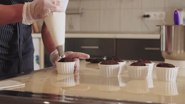 Decorating Handmade Chocolate Cupcake with White Vanilla Cream alt