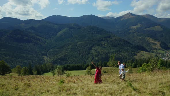 Kids Parents Against Mountains Dancing Grass Enjoying Time Blue Sky Background alt