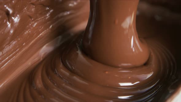 Melted chocolate pouring in a candy factory