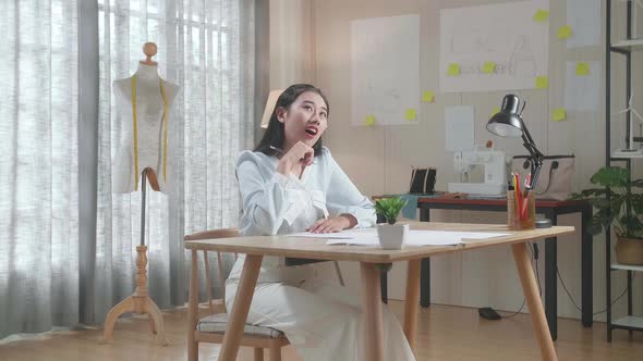 Asian Woman Designer Thinking While Drawing On The Layout Bond At The Office alt