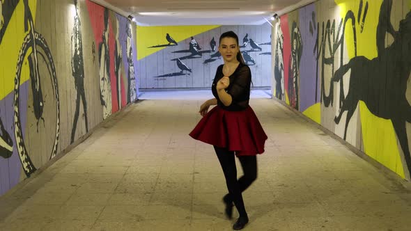 Stunning looking dancer dances in the underground passage alt