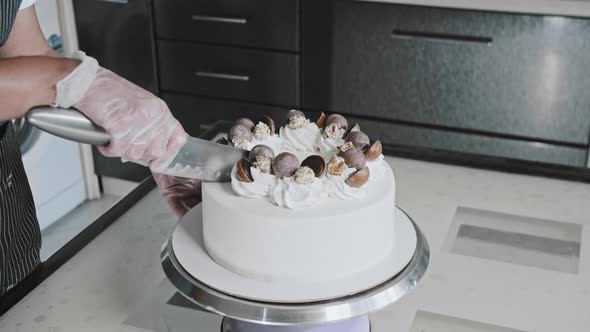 Pastry Chef Cuts a Fresh New Cake with a Knife alt