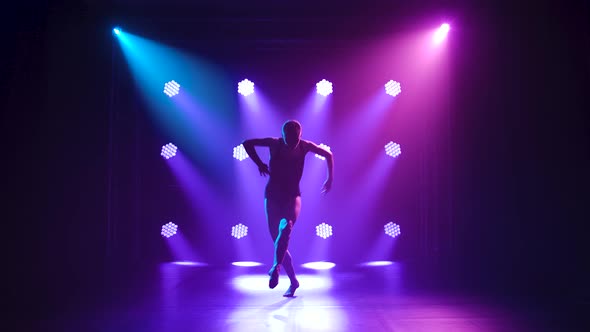 Professional Ballerina in Black Bodysuit Gracefully Dancing Ballet in Dynamic Spotlights and Smoke alt