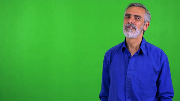 Old Senior Man Points To Camera with Finger - Green Screen - Studio alt