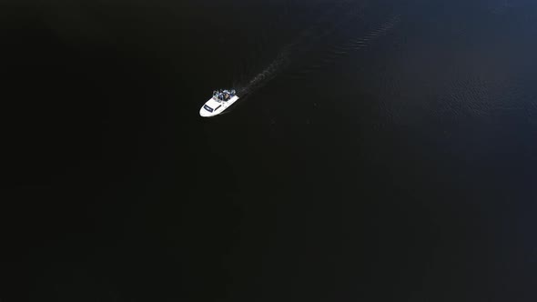 Bird'seye View of a White Boat Sailing Along the River