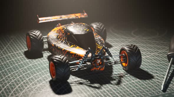 Assembled remote-controlled buggy car standing on a desk in the spotlight. 4KHD alt
