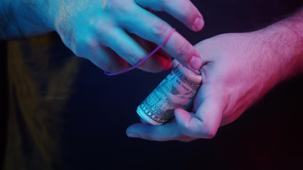 Putting Money in Bundle American Fifty Dollar Banknotes on Black Background alt