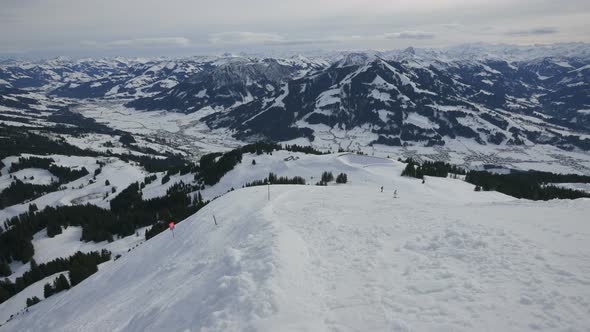 Skiers riding on a ski slope alt