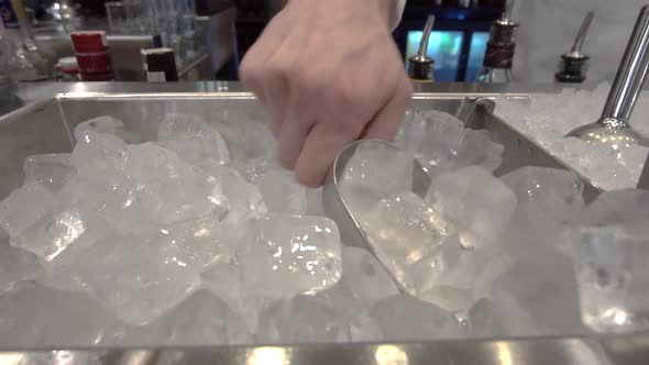 ice cubes for making a cocktail, a lot of edible ice in a stainless bowl