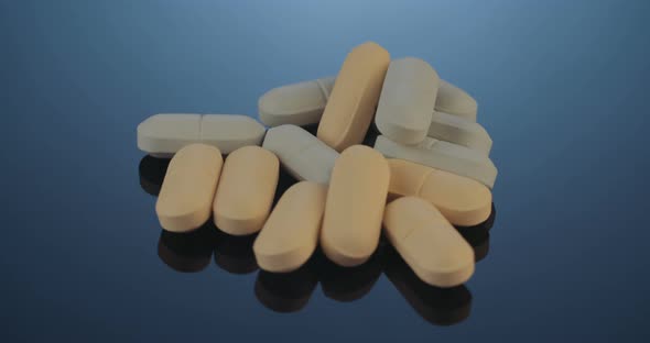 Prescription drugs - Capsules, pills, tablets on reflective background alt