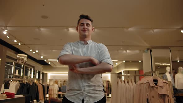 Portrait of Smiling Man in Summer Shirt Indoor of Fashionable Clothes Store alt