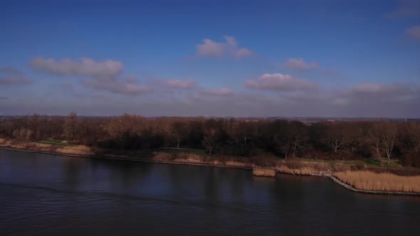 Water wave from a sail boat in a river. Navigation concept, aerial view alt