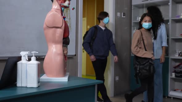 Teenage Pupils in Face Masks Entering Classroom alt