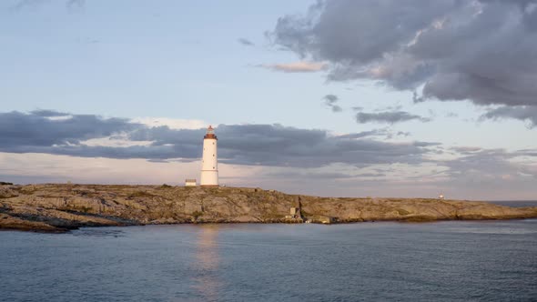 Aerial View Of Lille Torungen Lighthouse In Arendal, Norway On A Cloudy Day - drone shot alt
