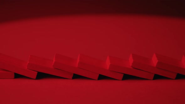 Red Dominoes Falling in Chain Reaction