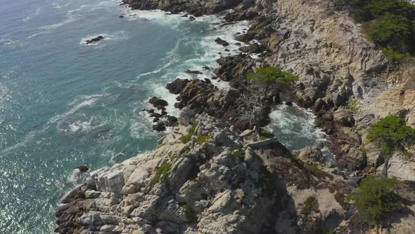 Slow Aerial Tilt Down Zoom in of the Rocky Shores of Big Sur Coast in California alt