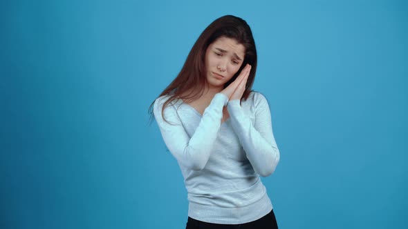 The Young Brunette Helpless Shyly Rolls Her Eyes and Asks for Forgiveness with Her Hands on Her alt