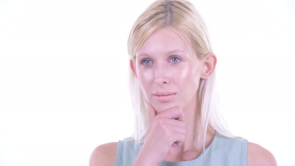 Face of Happy Young Blonde Woman Thinking and Looking Up alt