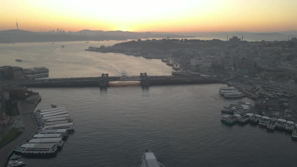 Aerial view of boat crossing under Galata Bridge. Aerial View of Istanbul at sunrise.