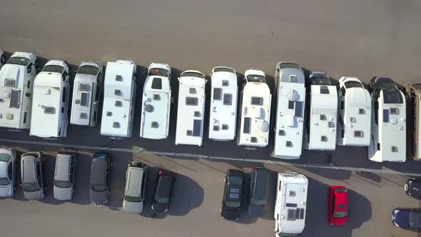 Aerial view of many camper vans on a parking lot. alt