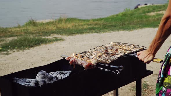 Man Preparing Barbecue On the Lake