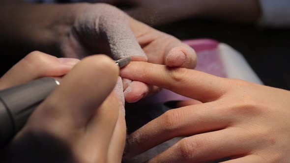 Anonymous Beautician Doing Manicure to Female Client