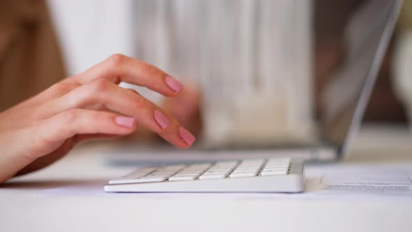Woman Uses White Numeric Keyboard for Making Calculations alt