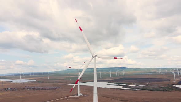 Alternative energy production on the wind power station with windmills alt