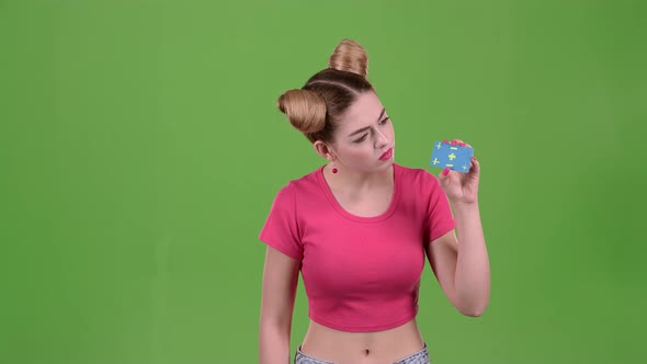 Teenager Advertises a Card and Shows a Finger Down. Green Screen. Slow Motion alt