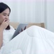 Young woman used tablet before sleeping on bed - VideoHive Item for Sale