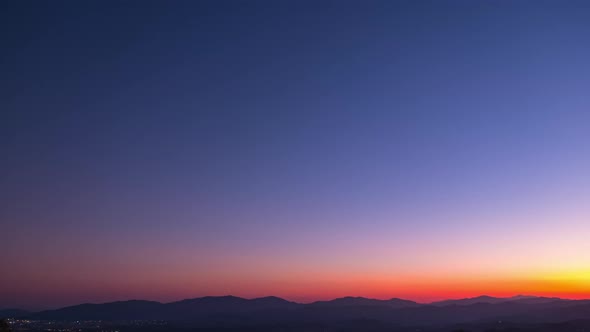 Day to Night Timelapse, Beautiful orange and violet sunset dusk scene above t alt