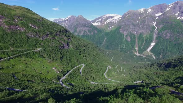 Aerial view of hairpin bends in Norwegian mountain pass alt