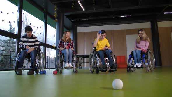 Disabled People in Wheelchairs Playing Boccia alt