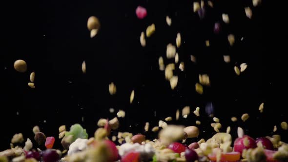 A Mixture of Dried Fruits and Nuts with Muesli Falls on the Table 