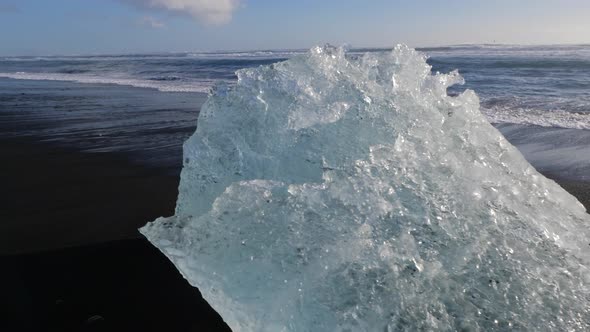 Iceland Jokulsarlon Diamond Beach With Iceberg Ice Chunks On Black Sand Ocean Shoreline